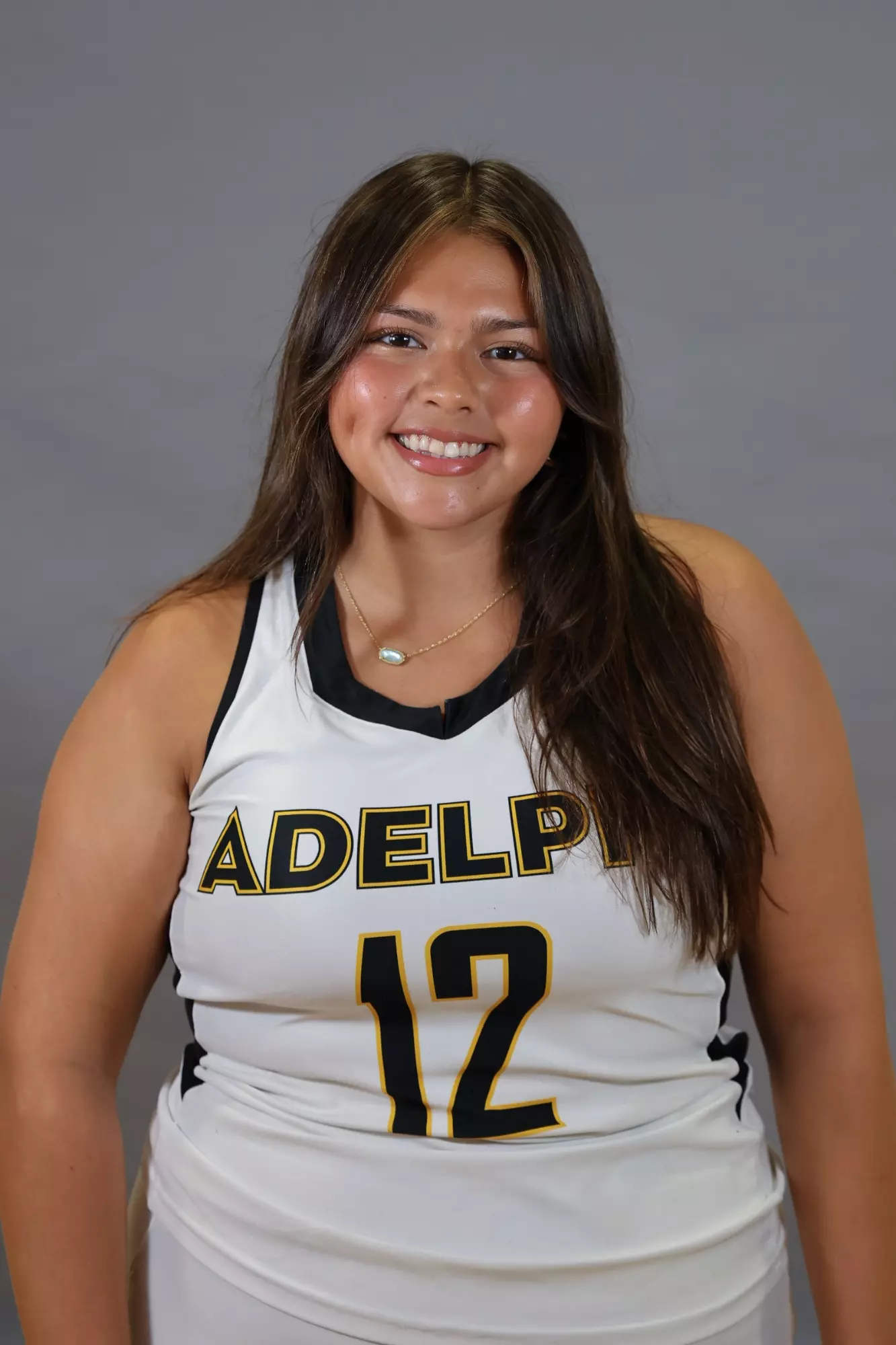 Hadash Roa, Adelphi University field hockey player, smiling in her team jersey