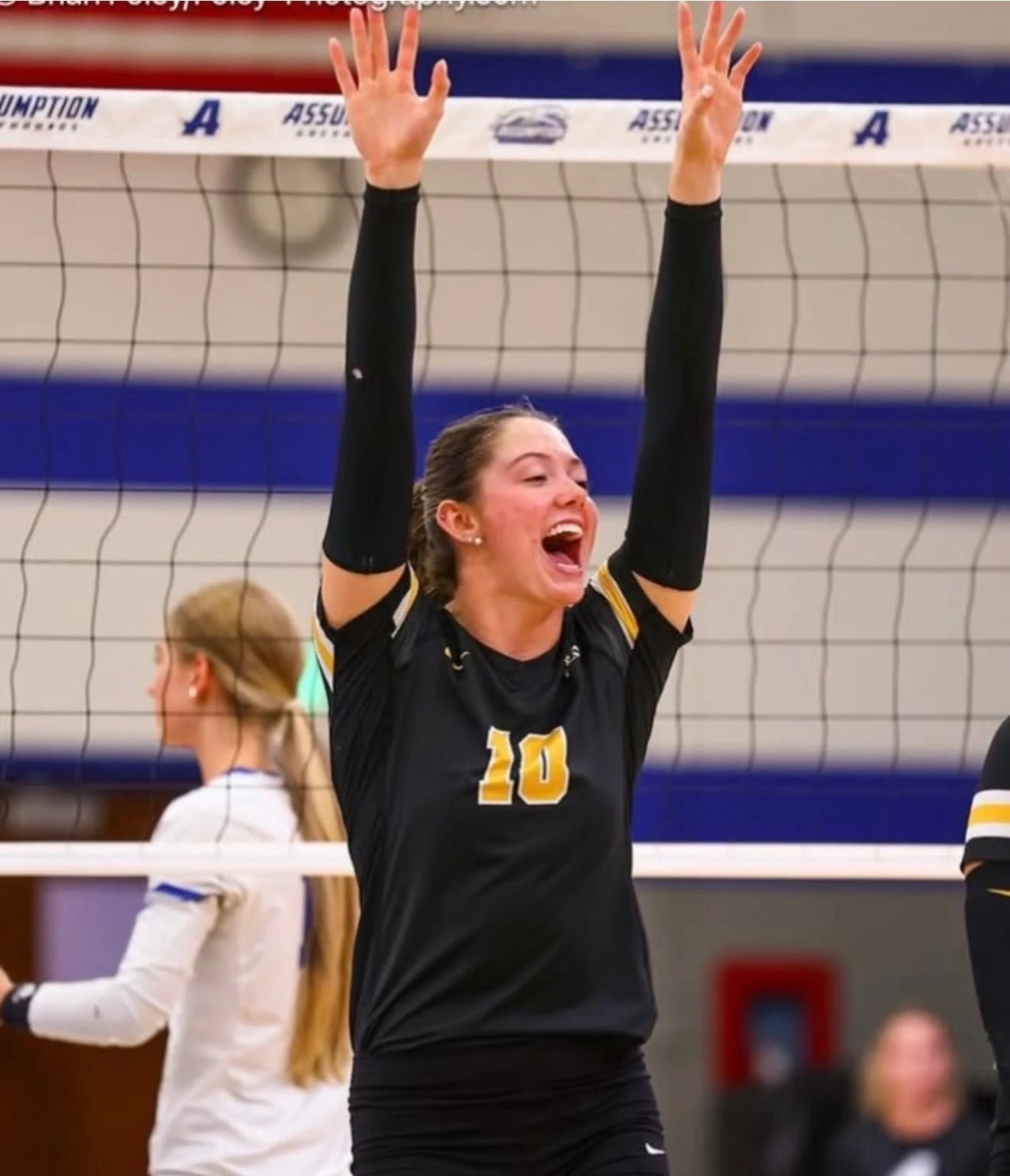 Mackenzie Casey celebrating with her Adelphi University volleyball teammates